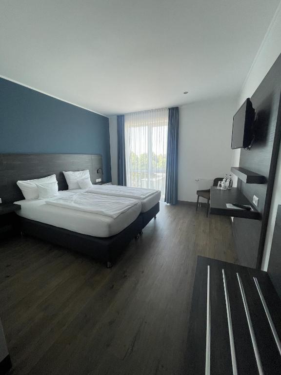 Postel nebo postele na pokoji v ubytování AiREA Hotel