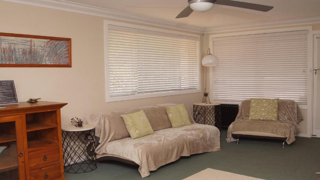 a living room with a couch and a chair at Pet Friendly Cockatoo Corner in Armidale