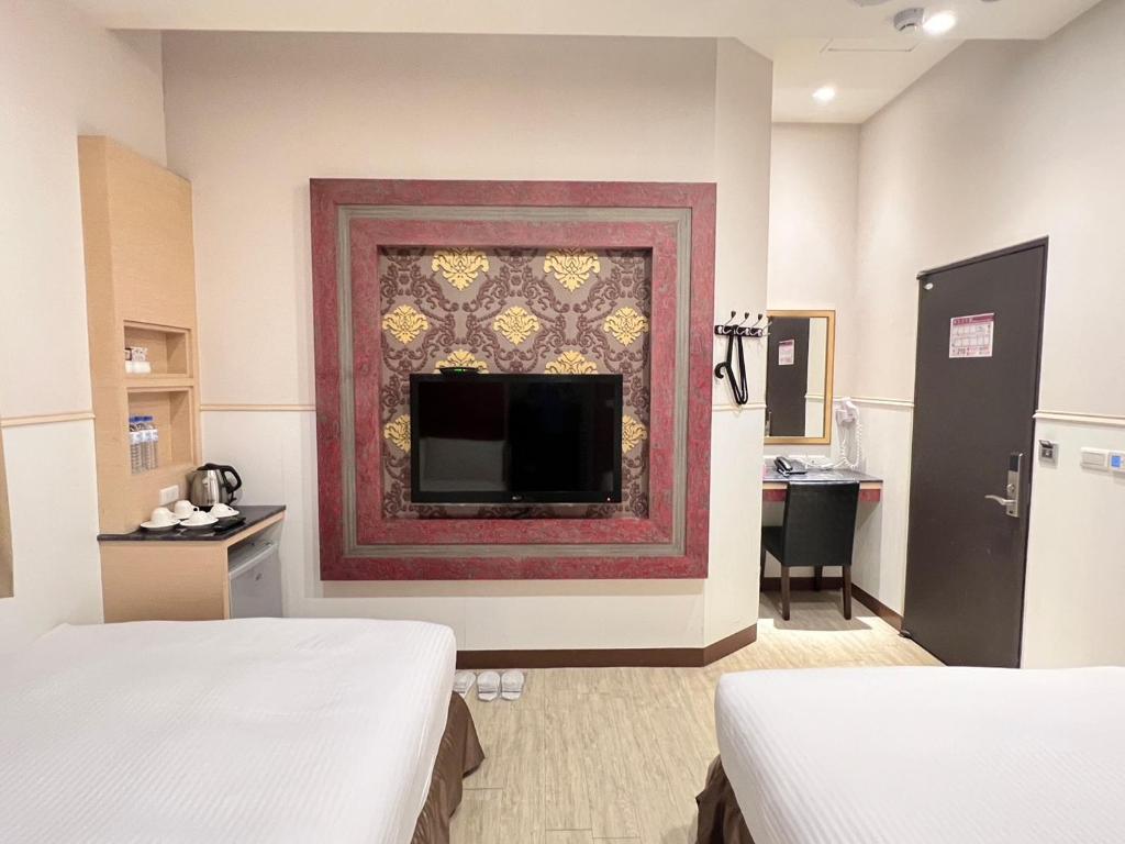 TV a/nebo společenská místnost v ubytování Kaishen Hotel
