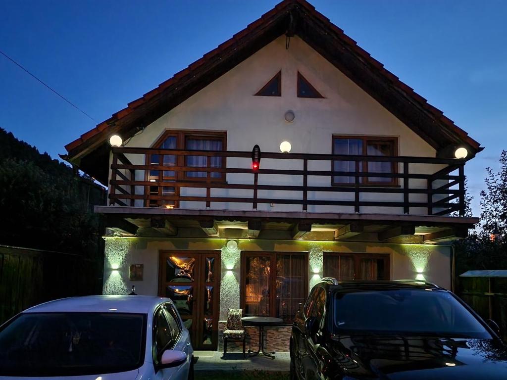 a house with a car parked in front of it at Ciprians' Home in Săcele