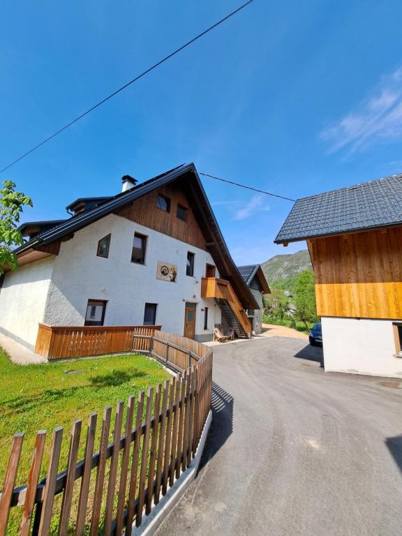 a house with a wooden fence next to a road at Old Mill House in Bohinj