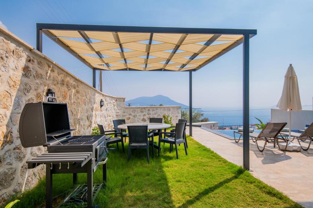 a patio with a table with a computer on it at Eco Villa ECE in Kalkan