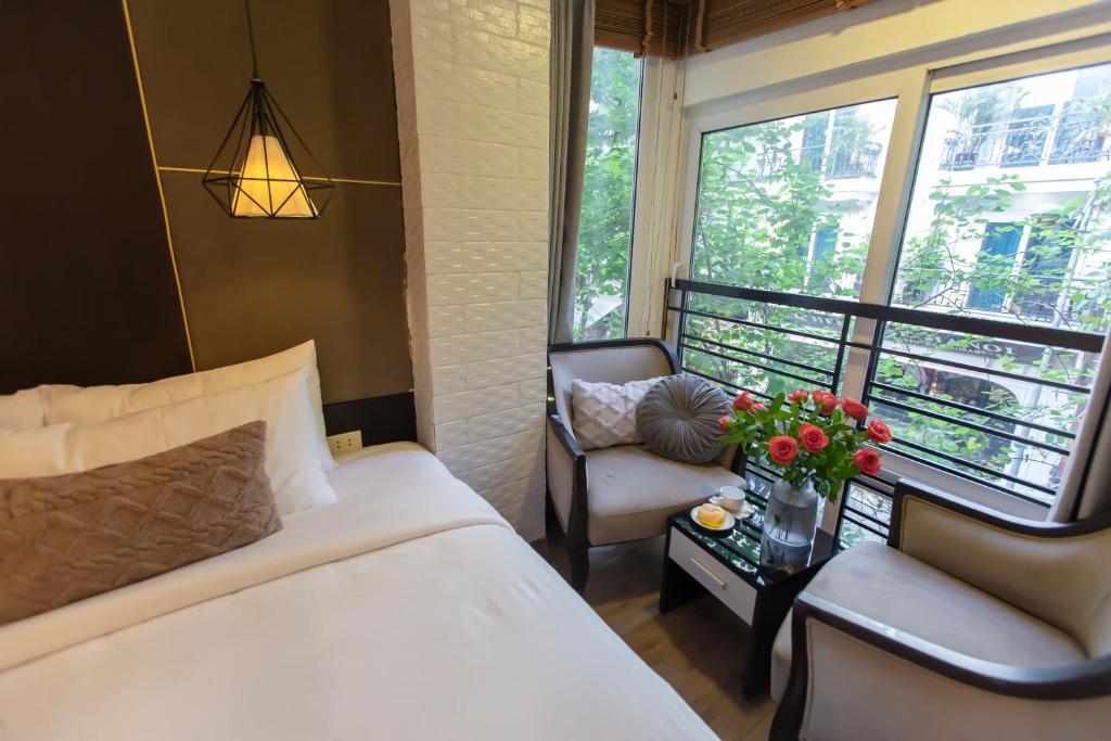 Postel nebo postele na pokoji v ubytování Keypad Hotel - 24 Hang Ga