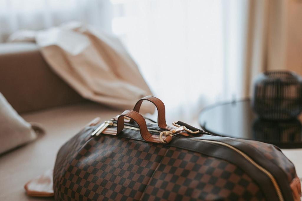 a suitcase sitting on the floor next to a table at MANNI das Hotel in Mayrhofen