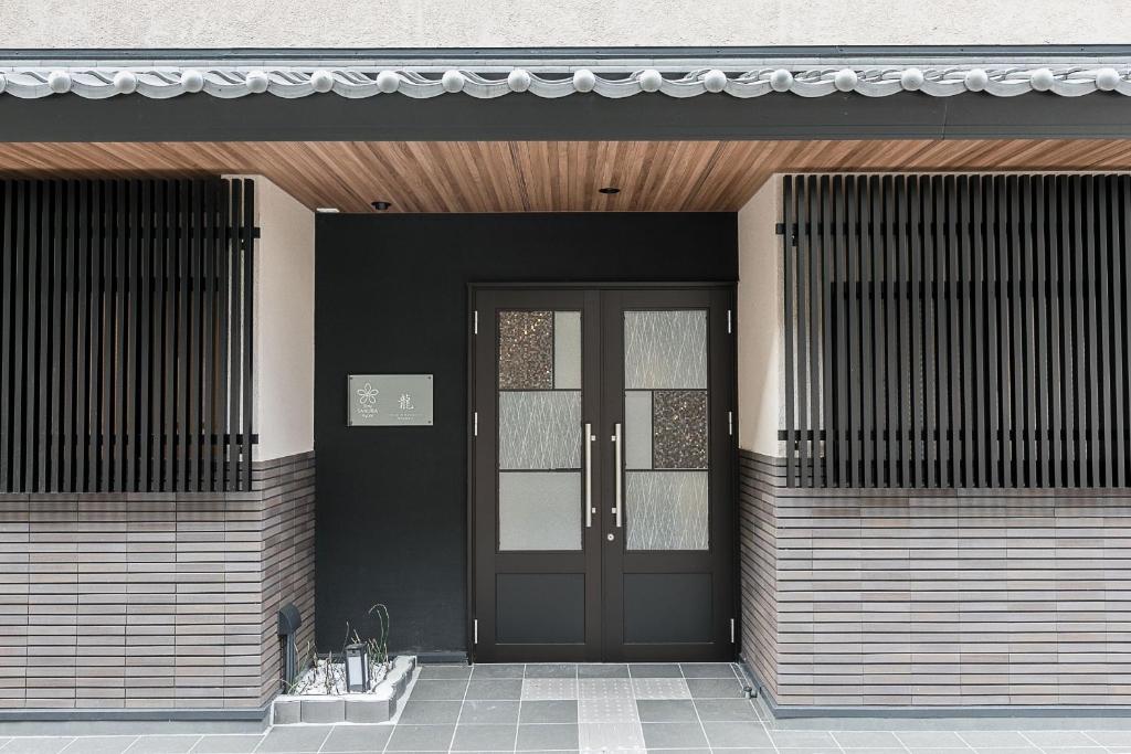 a front door of a house with a black door at Stay SAKURA Kyoto Dragon in Kyoto