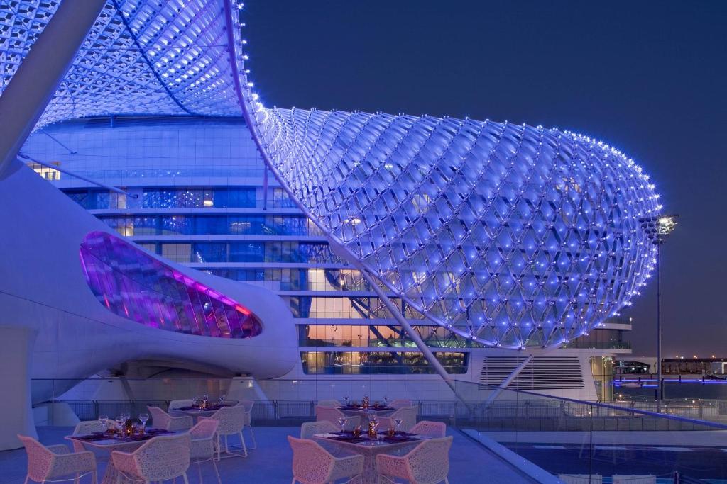 a view of a building at night with tables at W Abu Dhabi - Yas Island in Abu Dhabi