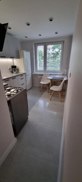 a kitchen with a table and a dining room at Apartament na 11go in Płock