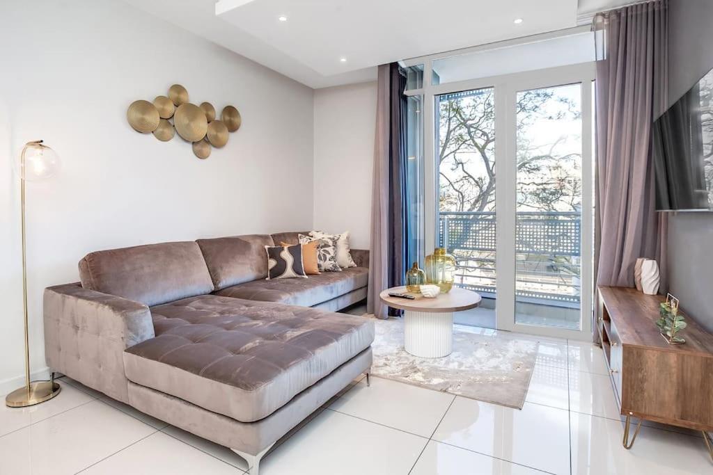 a living room with a couch and a table at The Median in Rosebank in Johannesburg