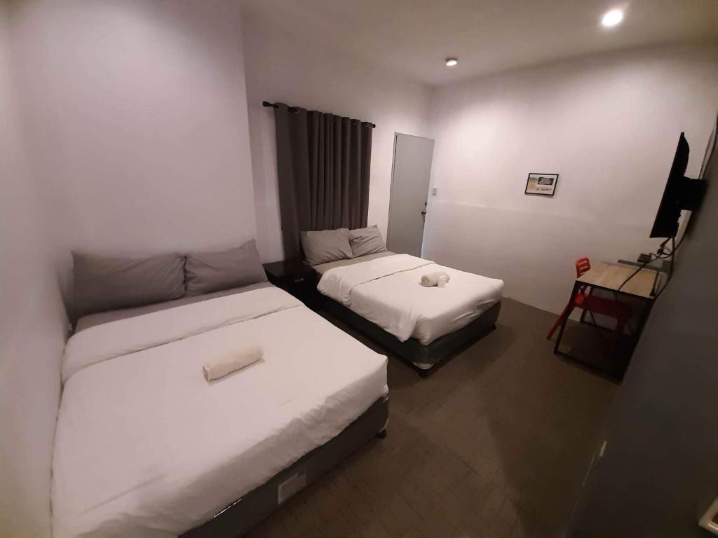 Postel nebo postele na pokoji v ubytování Hometown Hotel - Lacson Bacolod