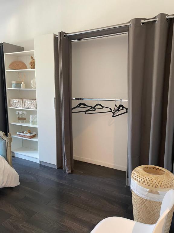a sliding glass door with hangers in a room at Spacieux T3 haussmannien in Toulon