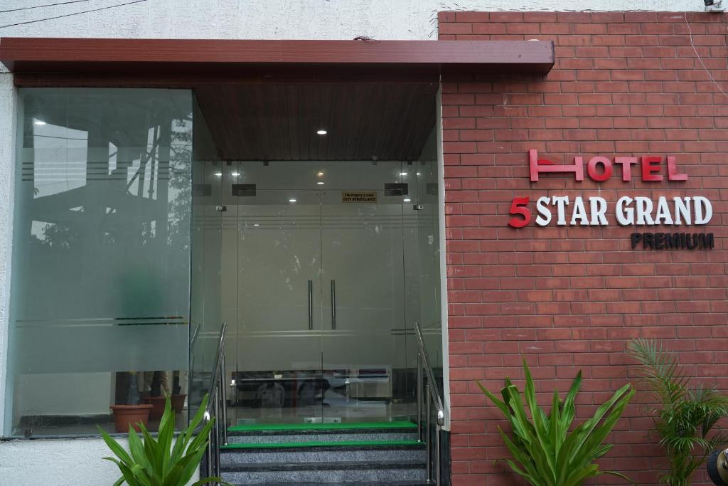 a hotel star grand entrance to a red brick building at 5 STAR GRAND- PREMIUM in Shamshabad