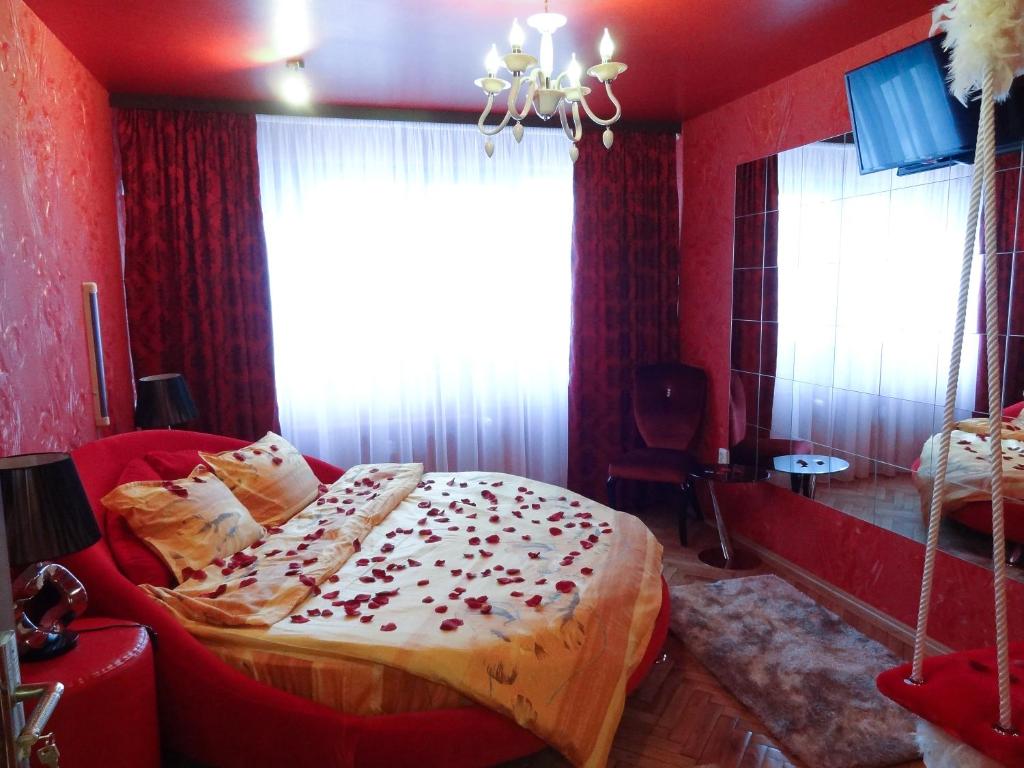 a bedroom with a bed in a red room at Amour Rouge Suite (Adults Only) in Galaţi