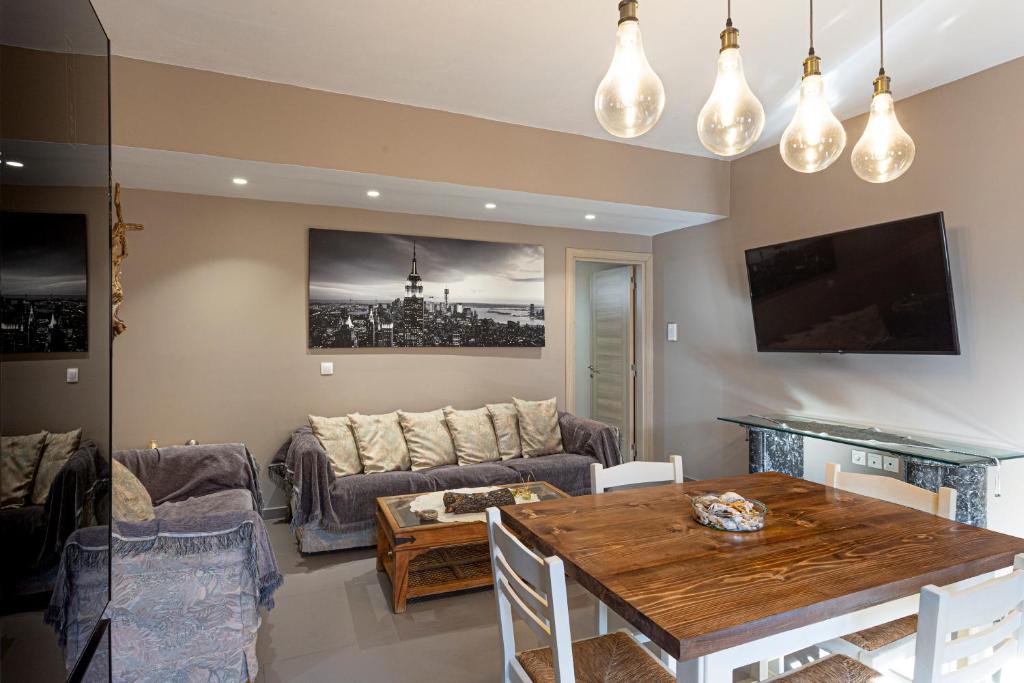 a living room with a table and a couch at Irinis Apartments Karfas, Chios in Chios