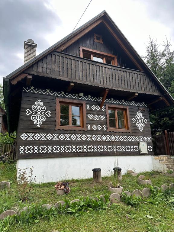 a house with a black and white design on it at Chalupa Čičmany in Čičmany