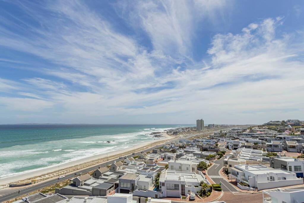 an aerial view of a beach with houses and the ocean at 801 Infinity 2 Bedroom Beachfront Apartment in Cape Town