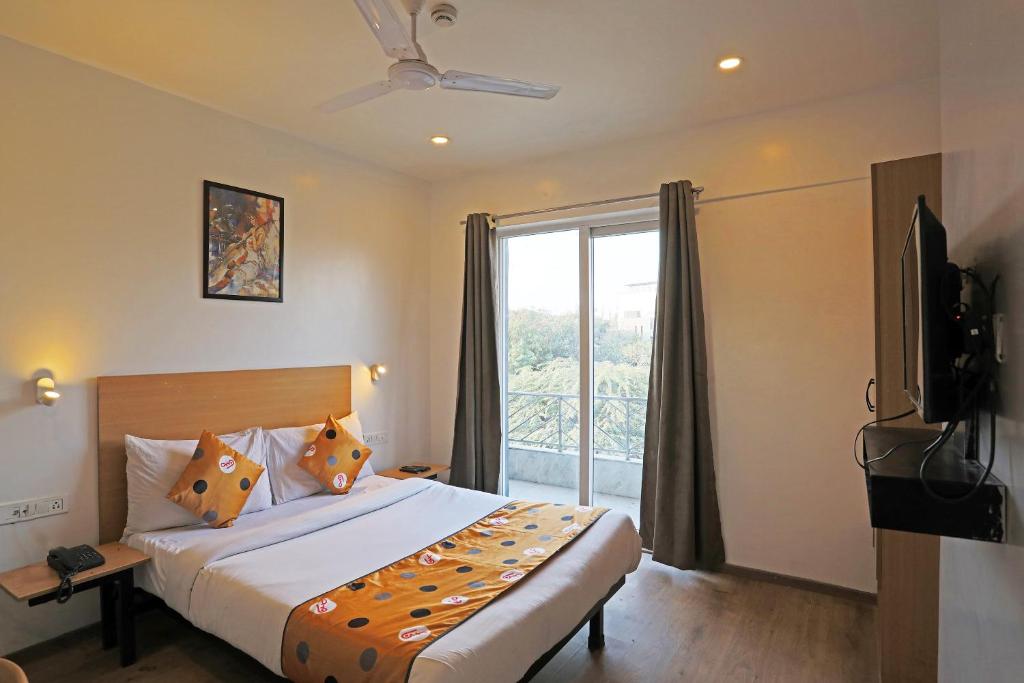 a bedroom with a bed and a large window at Hotel Silver Velvet "Unmarried couple and local ID allowed" in New Delhi