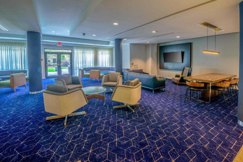 a lobby with a waiting room with chairs and a table at Courtyard by Marriott Wilkes-Barre Arena in Wilkes-Barre