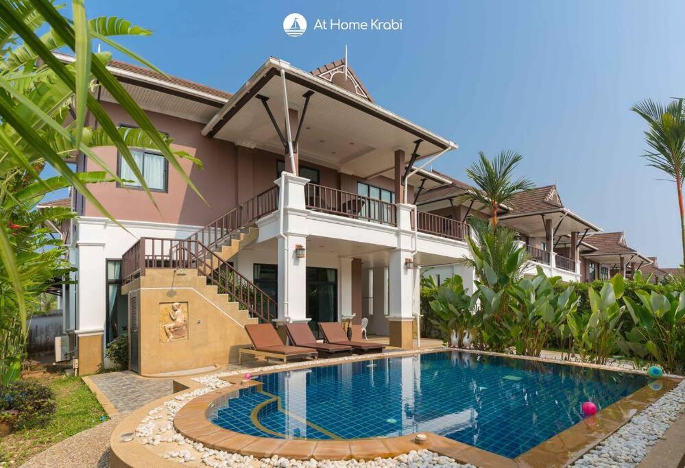a house with a swimming pool in front of it at Nadia's Ao Nang Pool Villa in Ban Chong Phli