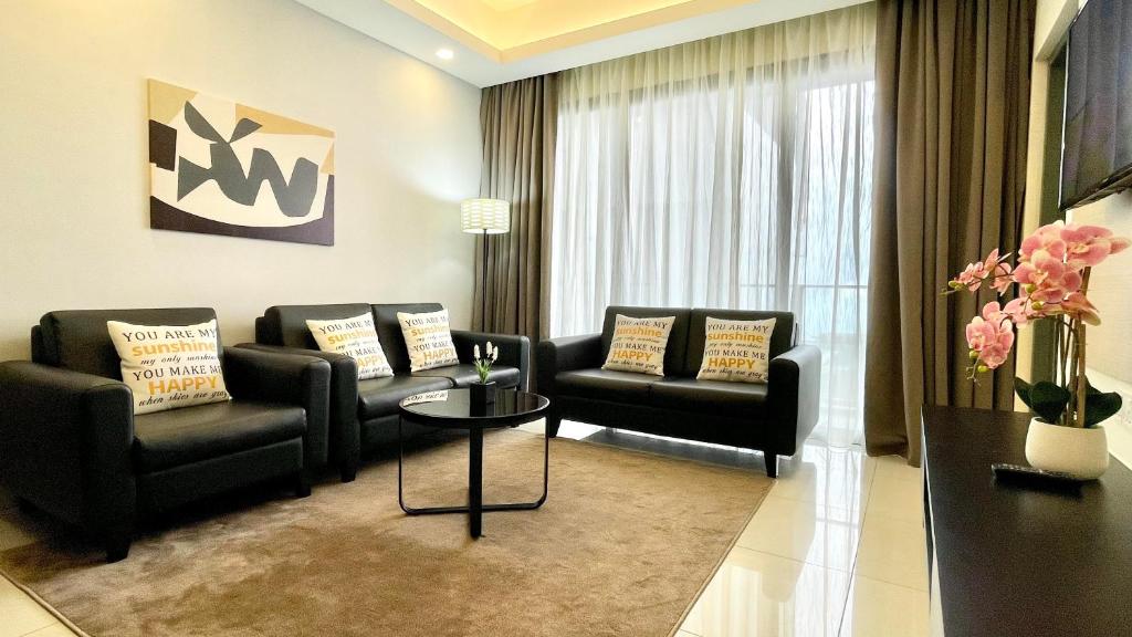 a living room with two couches and a table at Grand Ion Delemen by Horizon Homes in Genting Highlands