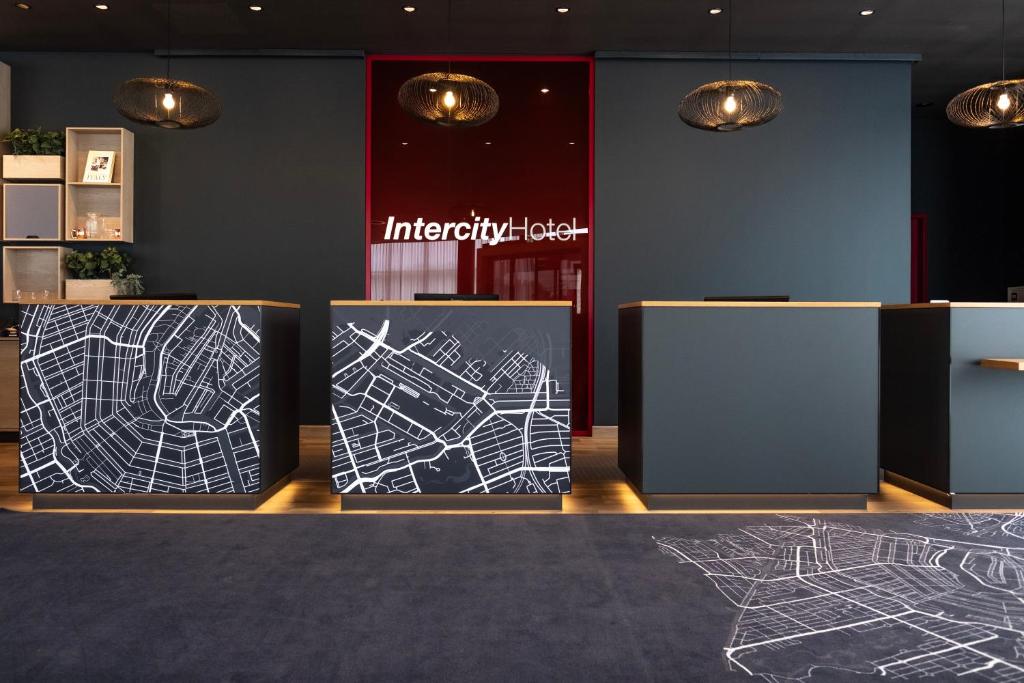 a lobby with two displays with drawings on them at IntercityHotel Karlsruhe in Karlsruhe