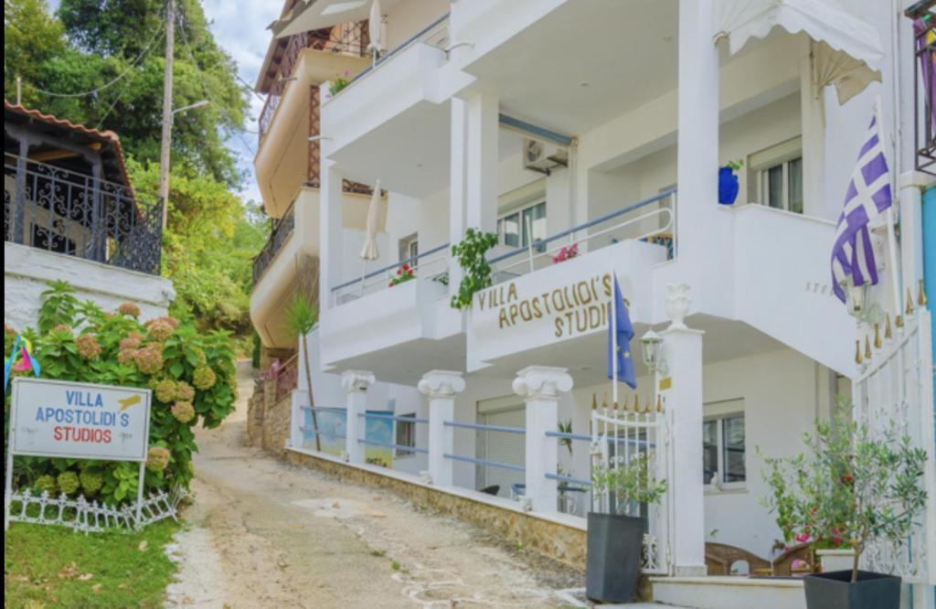 a row of white buildings with signs on them at Villa Apostolidis in Skala Potamias