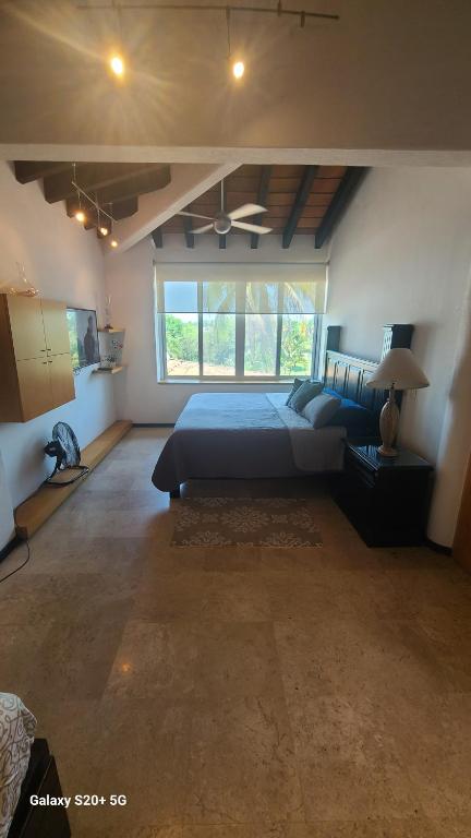 a bedroom with a bed and a large window at marina vallarta, One bedroom condo in Puerto Vallarta
