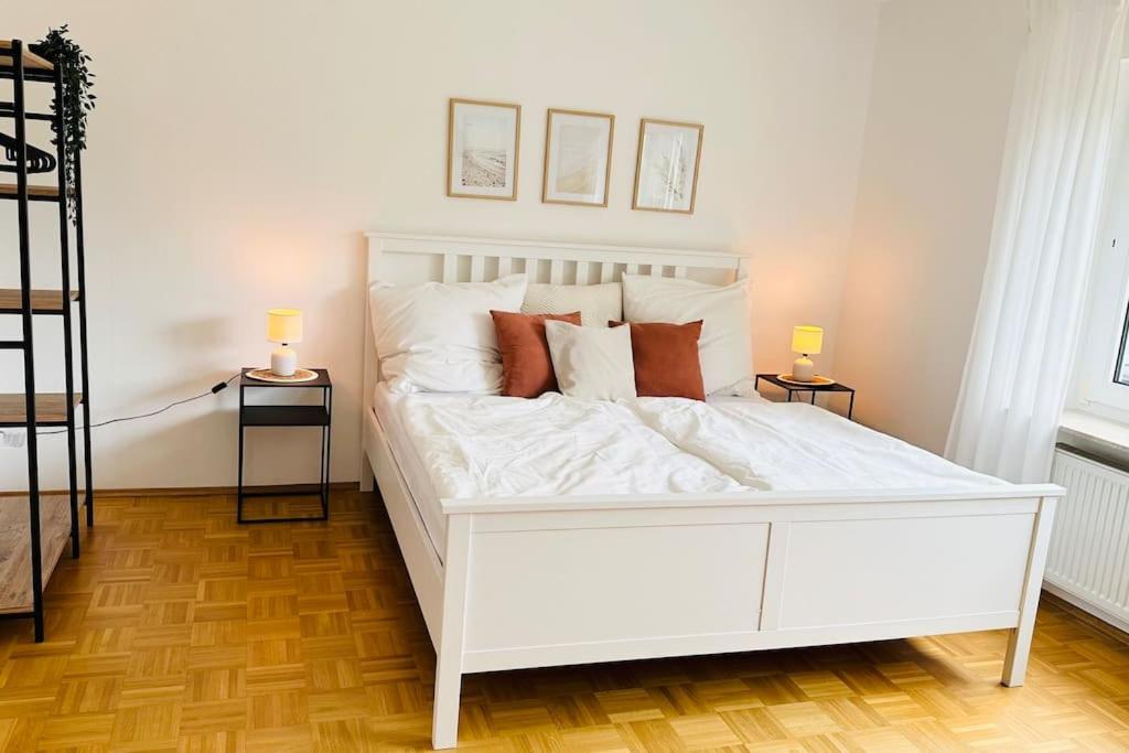 a white bed in a room with two side tables at Schöne Wohnung "Bethel" in Bad Hersfeld in Bad Hersfeld