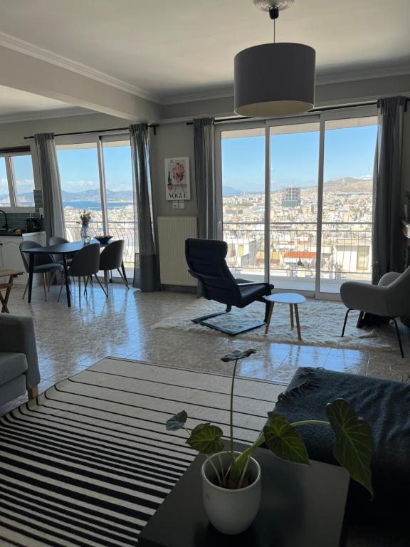 a living room with a view of a city at Porto Pireo Penthouse Sea View in Piraeus