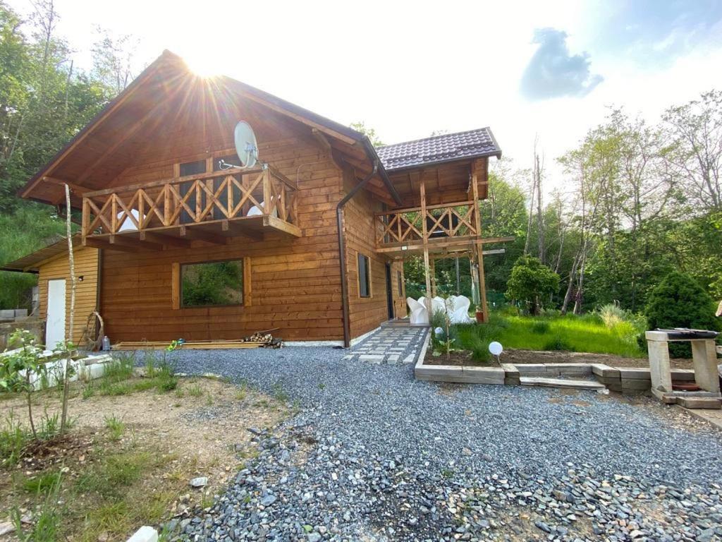 a log cabin with a gravel driveway in front of it at Cabana Luna in Valea Ierii