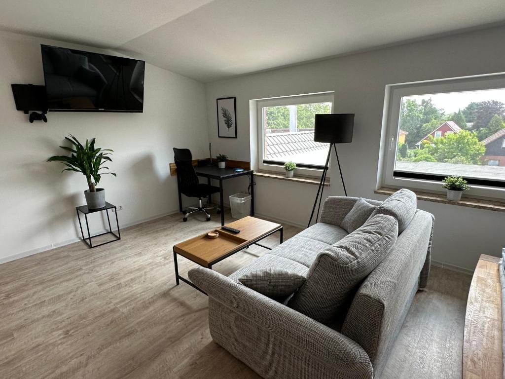 a living room with a couch and a table at MEINpartments Wolfsburg in Wolfsburg