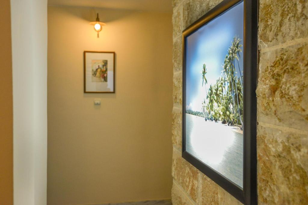a television in a room with a brick wall at Hotel Villa Perla Di Mare in Budva