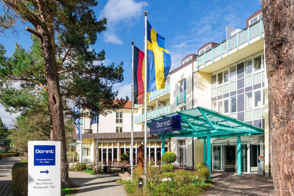 a hotel with a sign in front of a building at Dorint Seehotel Binz-Therme in Binz