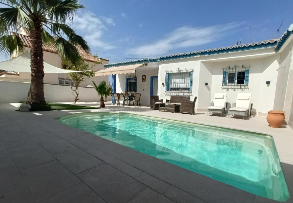 a swimming pool in front of a house at Stunning Villa in Aguadulce, Almería Private Pool 400 sqm area 800m Beach in Aguadulce