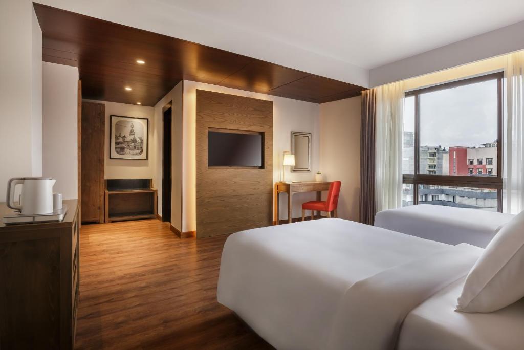 Postel nebo postele na pokoji v ubytování Dusit Princess Kathmandu
