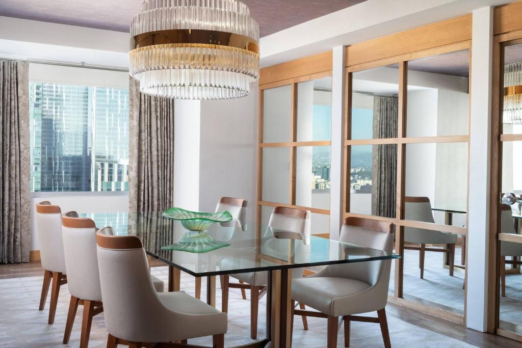a dining room with a glass table and chairs at The Ritz-Carlton, Los Angeles L.A. Live in Los Angeles