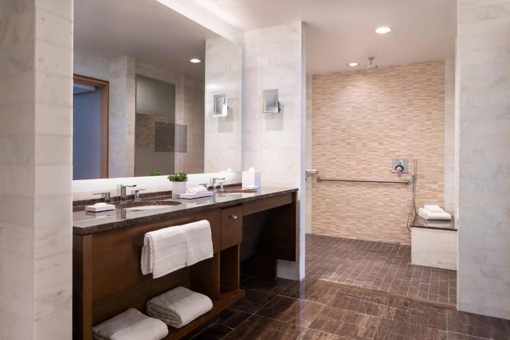 a bathroom with a large sink and a shower at The Ritz-Carlton, Los Angeles L.A. Live in Los Angeles
