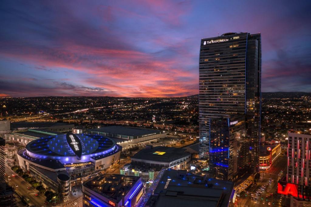 a night view of a city with a tall building at The Ritz-Carlton, Los Angeles L.A. Live in Los Angeles