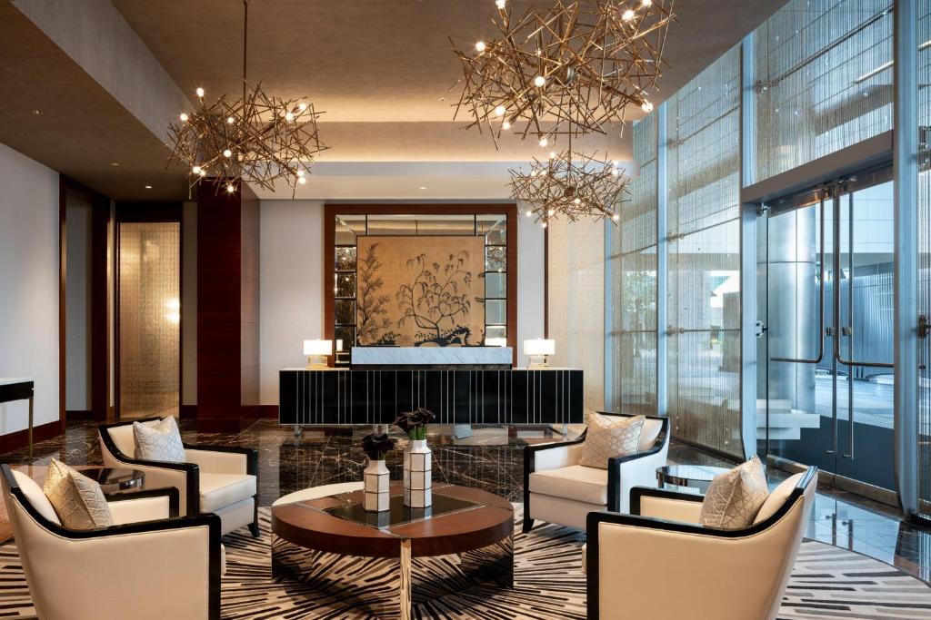 a hotel lobby with a table and chairs at The Ritz-Carlton, Los Angeles L.A. Live in Los Angeles