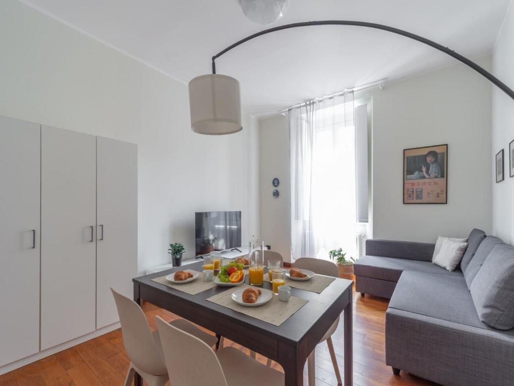 a living room with a table and a couch at The Best Rent - Spacious Two-bedroom apartment in Porta Romana in Milan