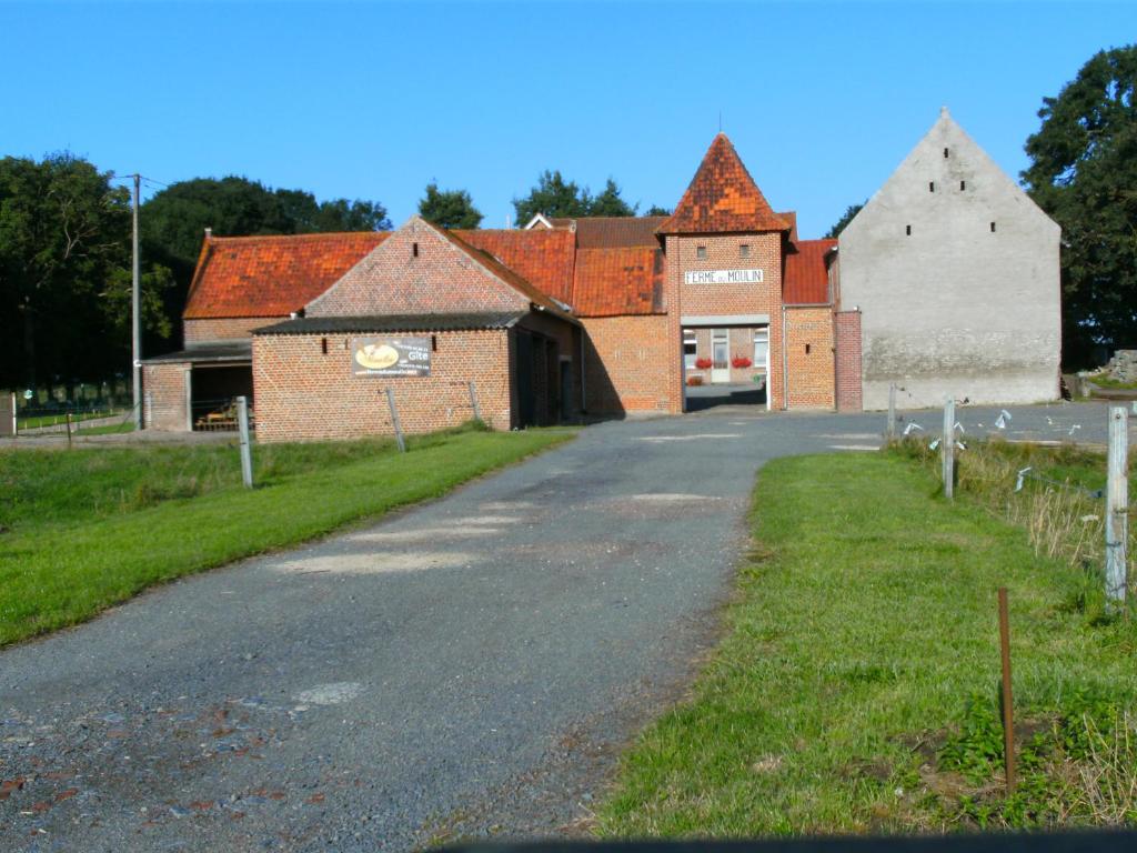 an empty road in front of a brick building at Gîte ferme du moulin in Tournai