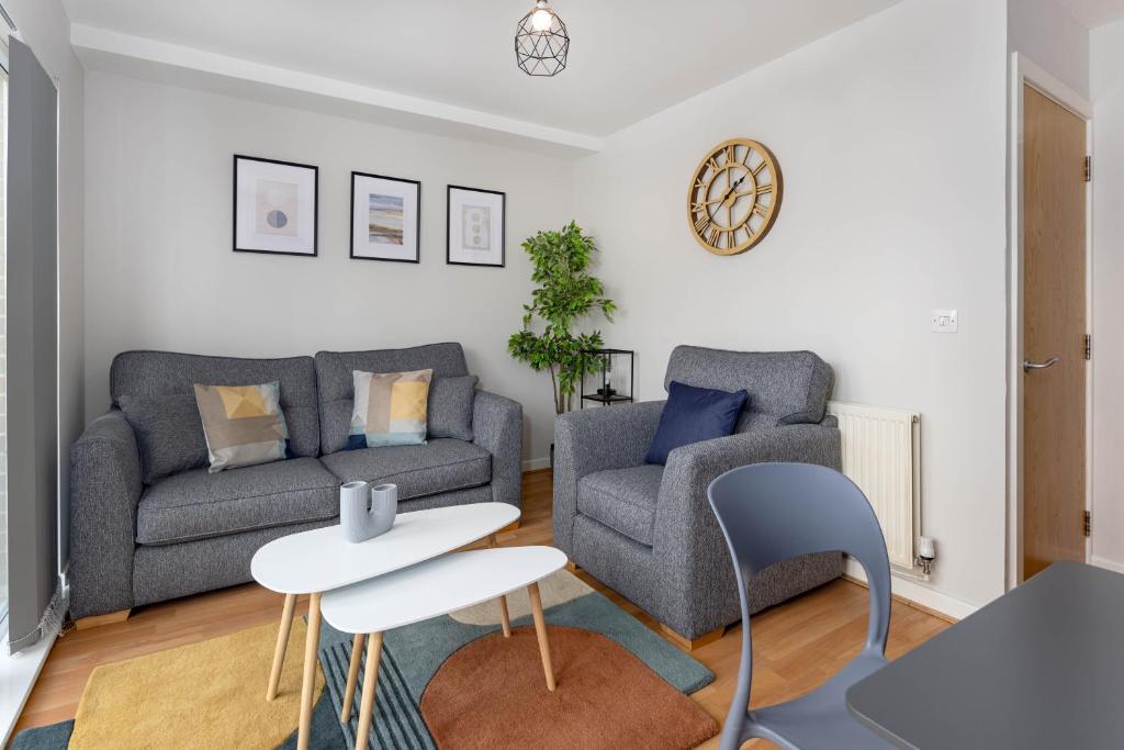 a living room with a couch and a table at Host Liverpool - Spacious Home for Family & Groups in Liverpool