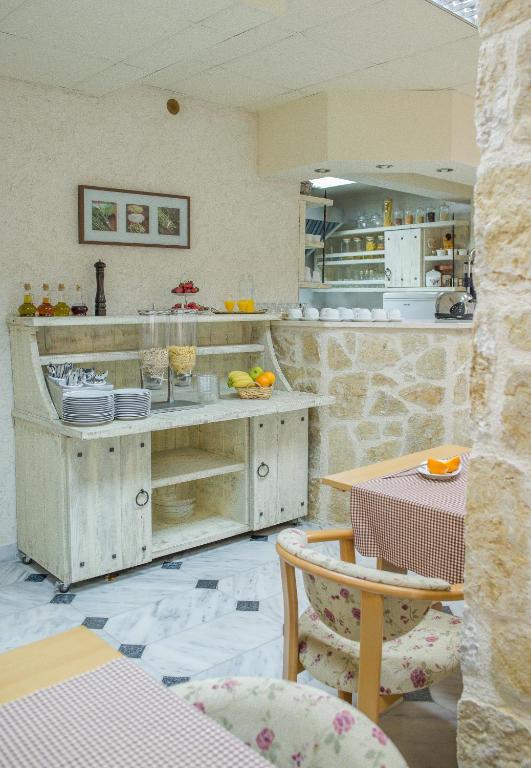 a kitchen with a counter with plates on it at Hotel Villa Perla Di Mare in Budva