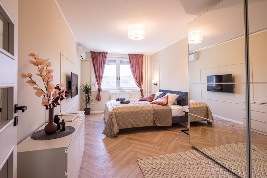 a bedroom with a bed and a large window at Stock Room apartman in Budapest