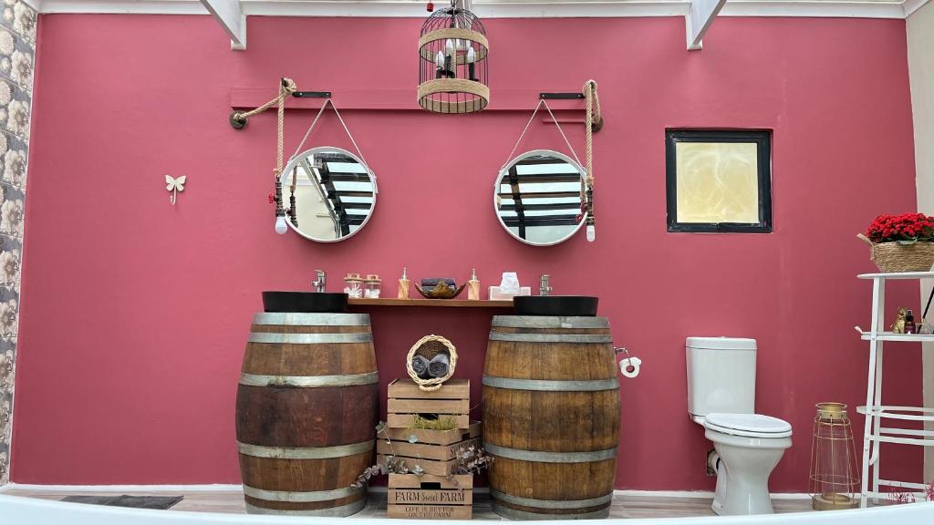 a bathroom with red walls and two wooden barrels at The Franschhoek Stargazing Dome in Franschhoek