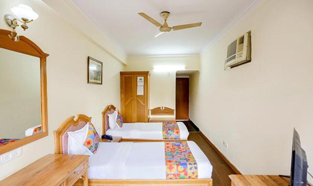 Postel nebo postele na pokoji v ubytování FabHotel Altus