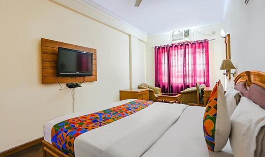 Postel nebo postele na pokoji v ubytování FabHotel Altus