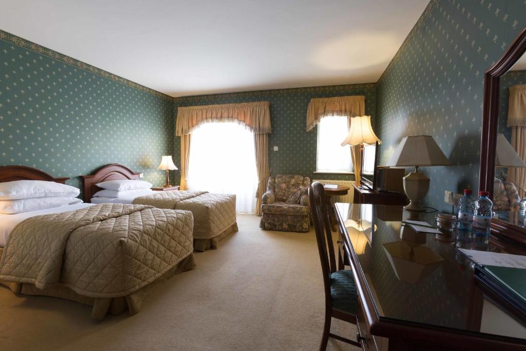 Postel nebo postele na pokoji v ubytování Sheedy's Boutique Hotel