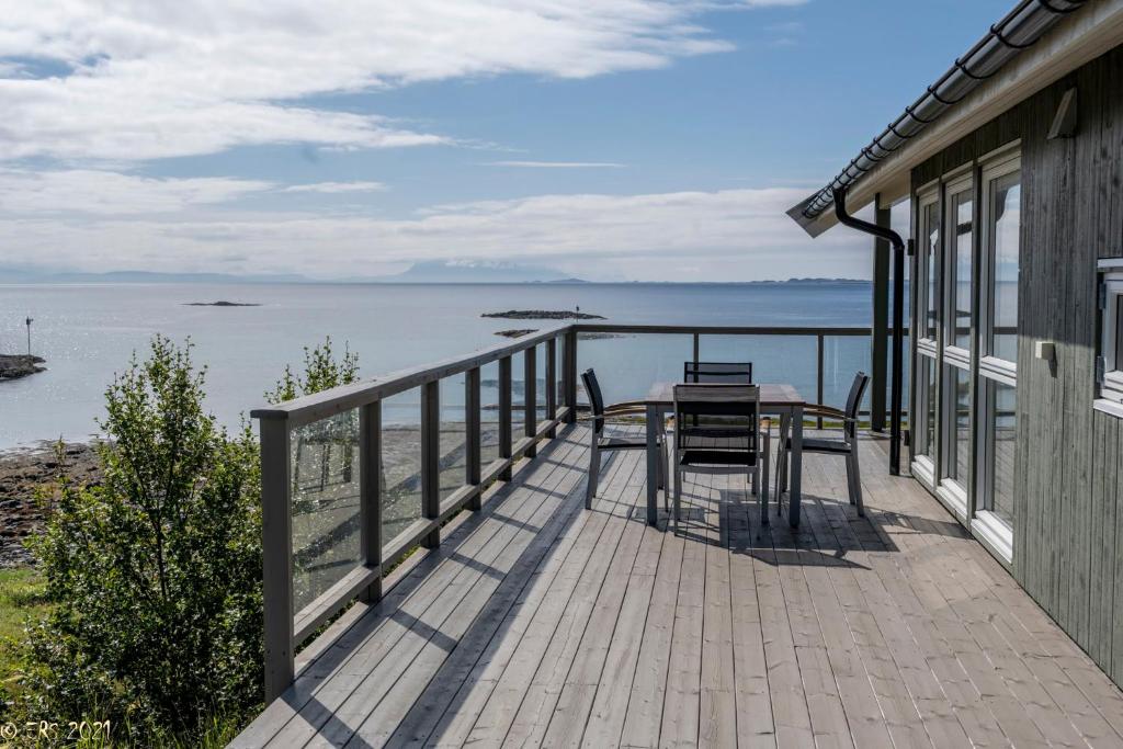 a balcony of a house with a table and chairs at Arctic Panorama House in Lødingen