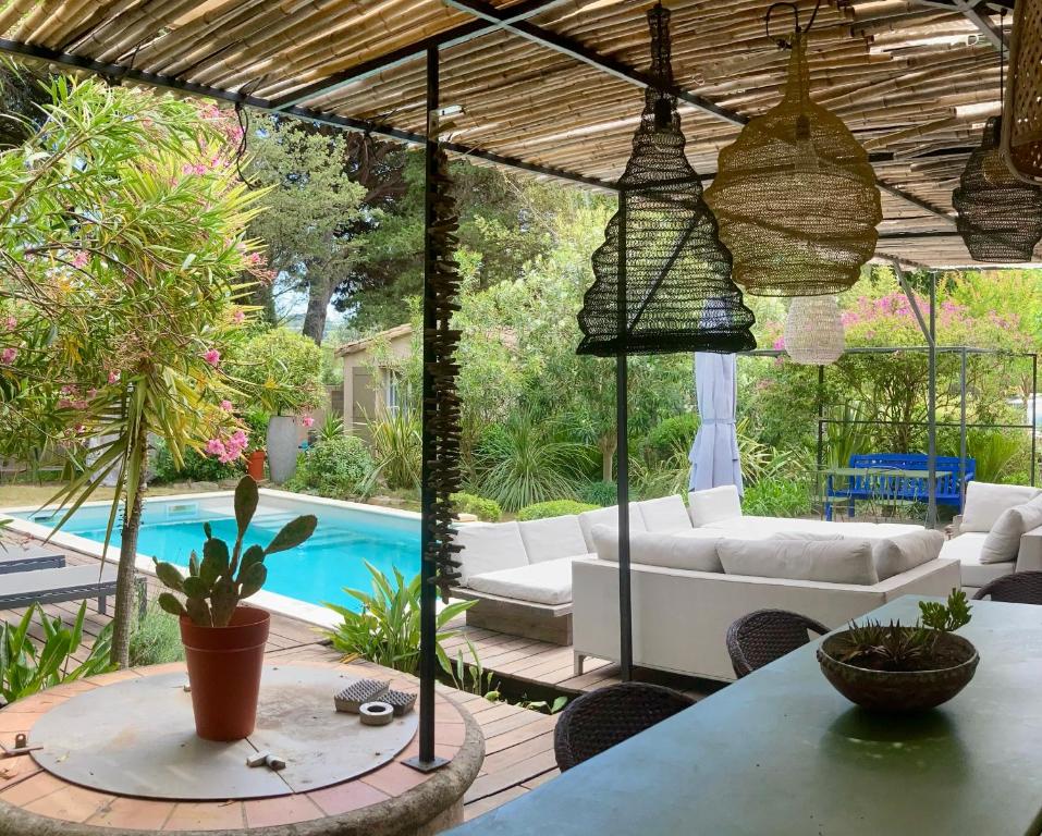 a living room with a table and a pool at La Vagabonde in Saint-Tropez