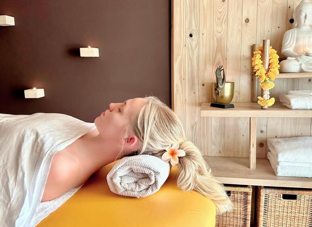 a woman laying on a bed in a room at Buddhas Bed & Wellness - B&B - FEEL GOOD FOOD - kreativ - gesund - vegan 